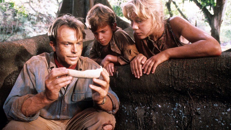 Sam Neill alongside co-stars Joseph Mazzello and Ariana Richards in the 1993 film Jurassic Park