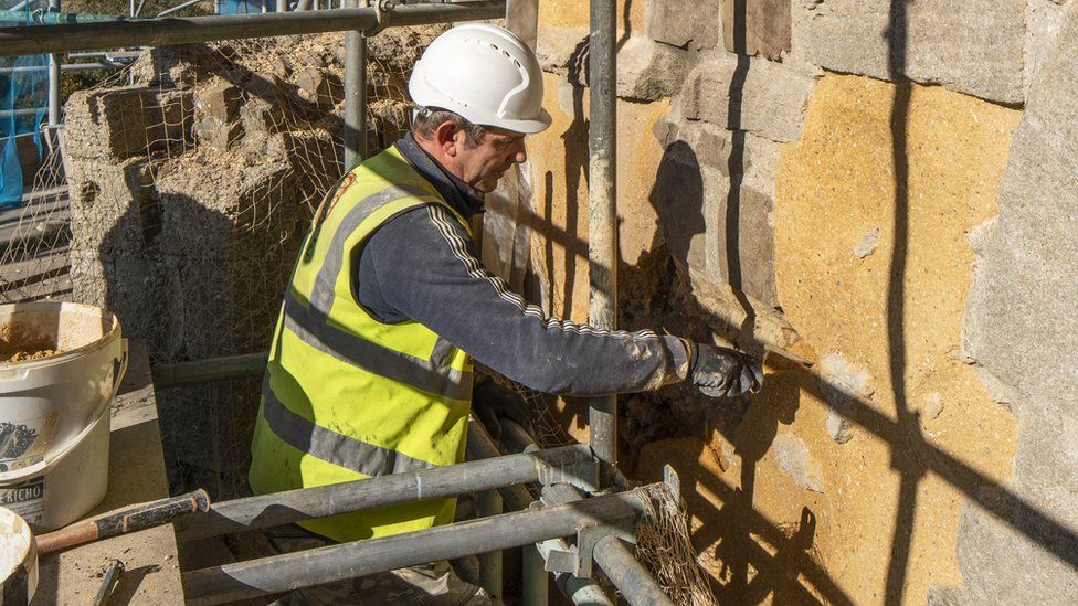 A workman working on the castle