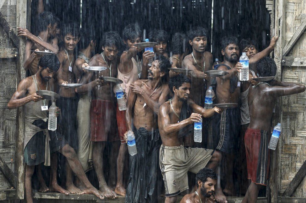 Migrants collect rainwater at a temporary refugee camp near Kanyin Chaung jetty, outside Maungdaw township, Myanmar, 4June 2015