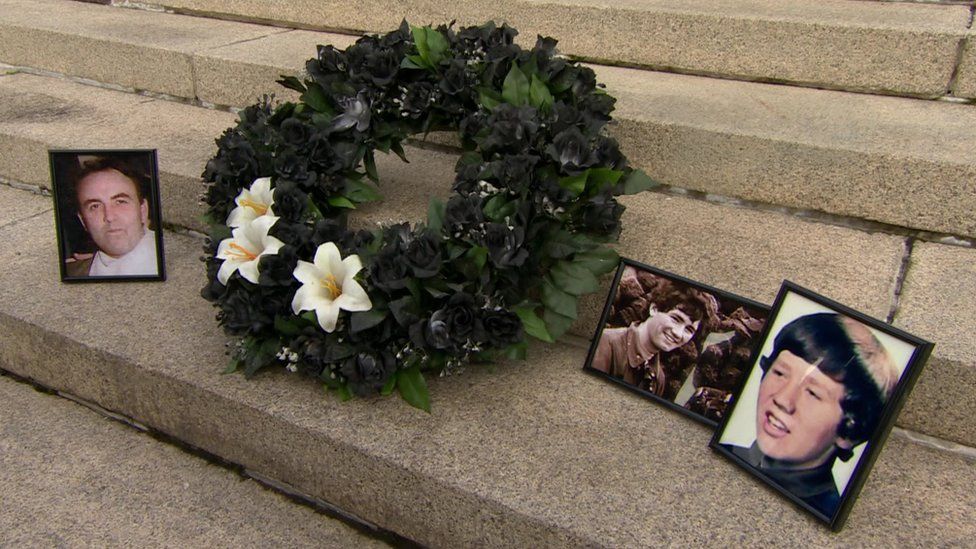 The families laid a wreath adorned with three lilies, one for each of the victims who are yet to be found