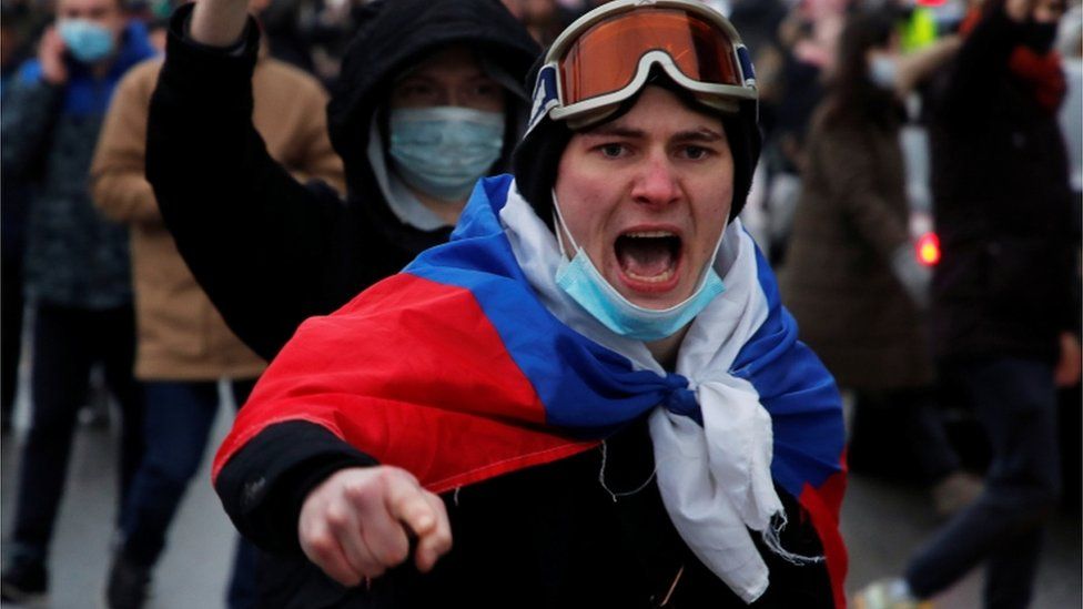 A man wearing a Russian flag shiuts during a rally in support of jailed Russian opposition leader Alexei Navalny in Saint Petersburg