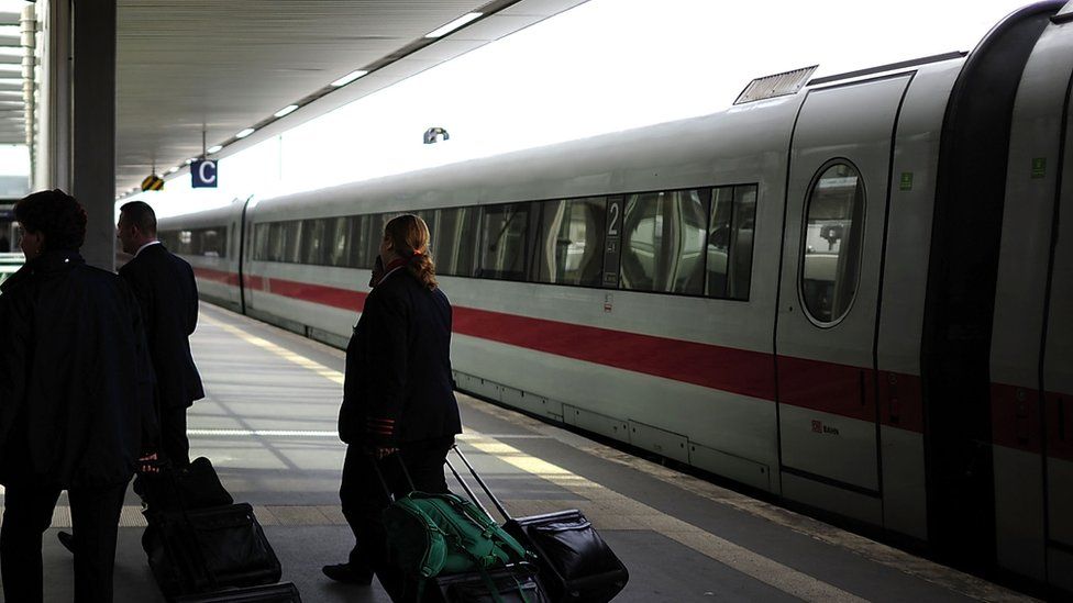 Man survives 25km ride hanging on to side of German train - BBC News