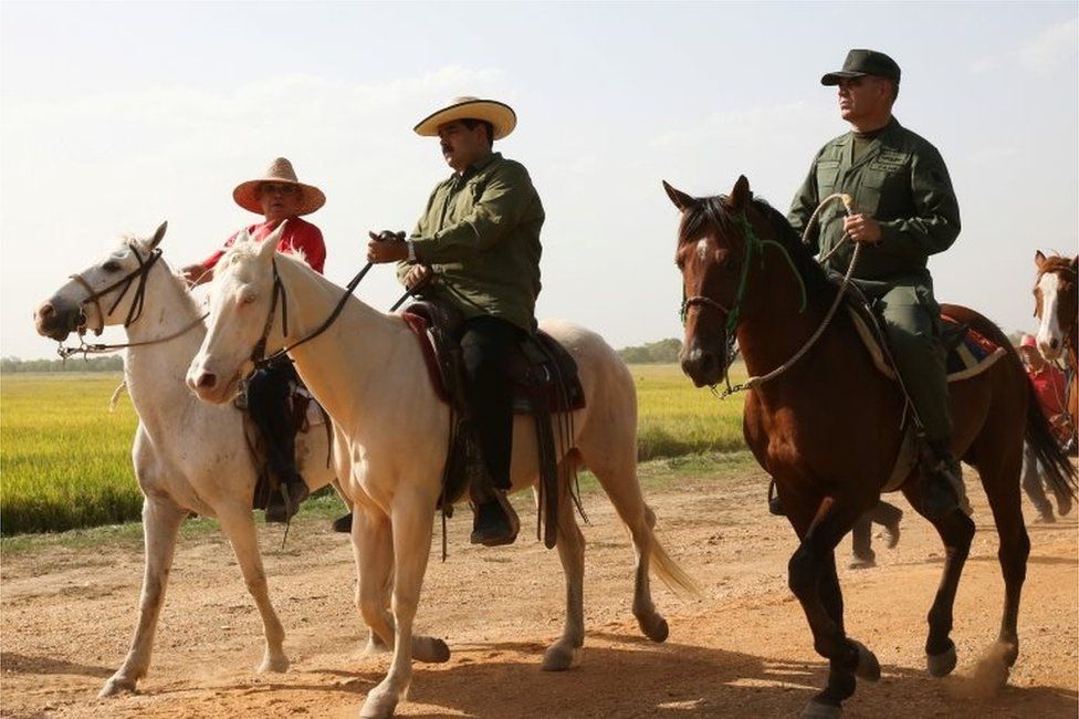 Venezuela"s President Nicolas Maduro (C) and Venezuela"s Defense Minister Vladimir Padrino Lopez (R) ride horses, during a visit to planting fields in Calabozo, Venezuela April 5, 2017.