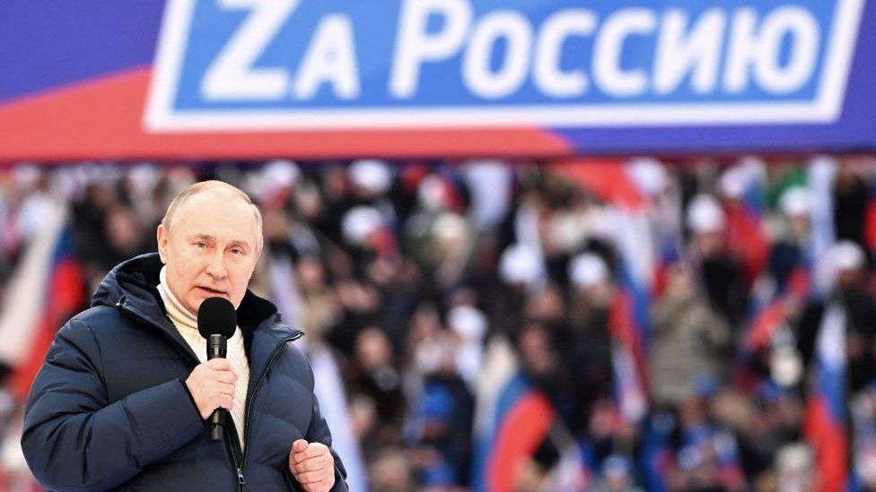Russian President Vladimir Putin gives a speech at a concert marking the eighth anniversary of Russia's annexation of Crimea