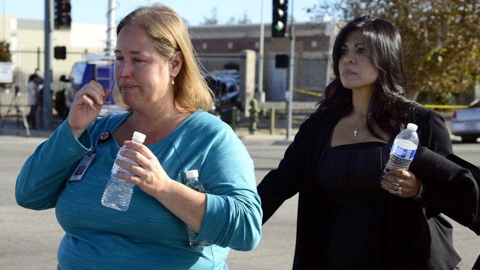 Evacuees leave the scene of a shooting at the Inland Regional Center in San Bernardino, California, USA, 02 December 2015
