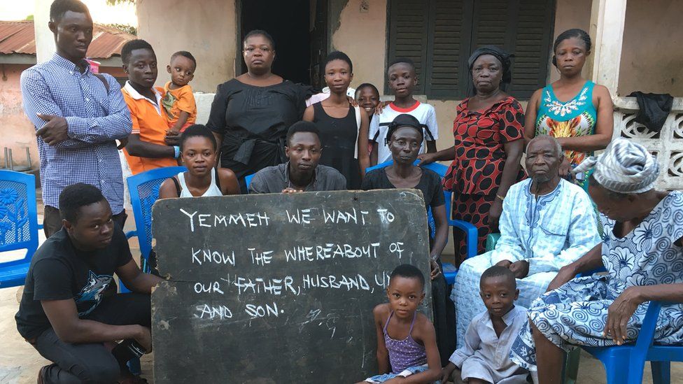 Martin Kyere with members of the family of Peter Mensah who was among the victims. His wife, dressed in black is holding the board at far right. Centre is Peter’s son Isaac (grey shirt – aged 26), daughter Lauretta (white vest – aged 20) and Clement (black t-shirt, 21)