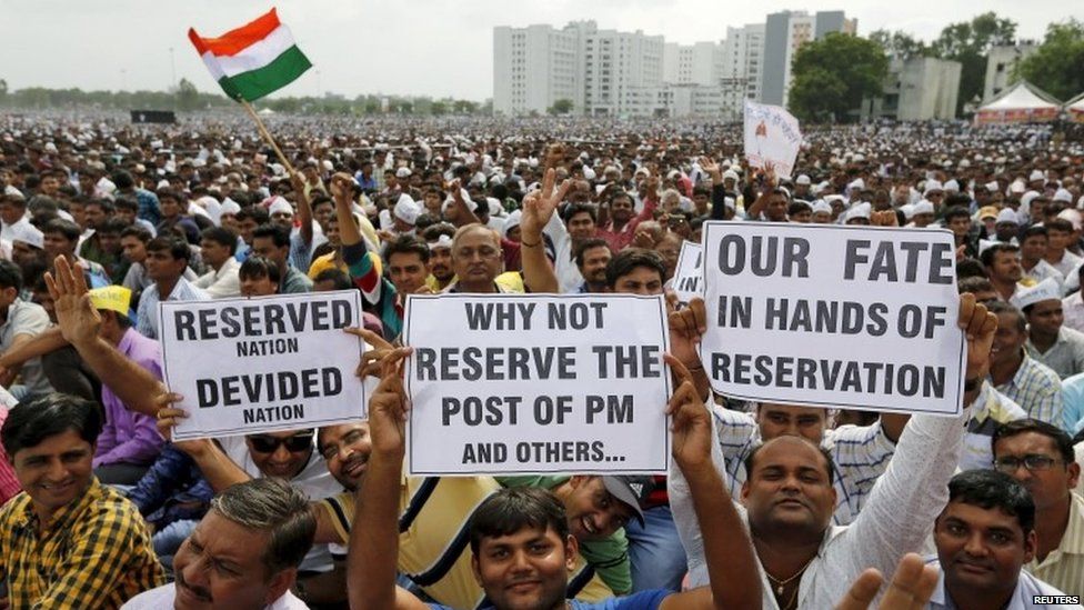 Members of the Patel community display placards as they attend a protest rally in Ahmedabad, India, August 25, 2015.