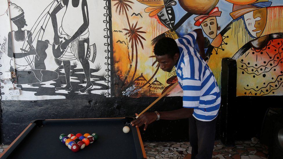 A man playing pool in Bakau, The Gambia - Monday 20 February 2017
