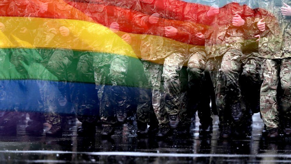 A rainbow flag and UK soldiers