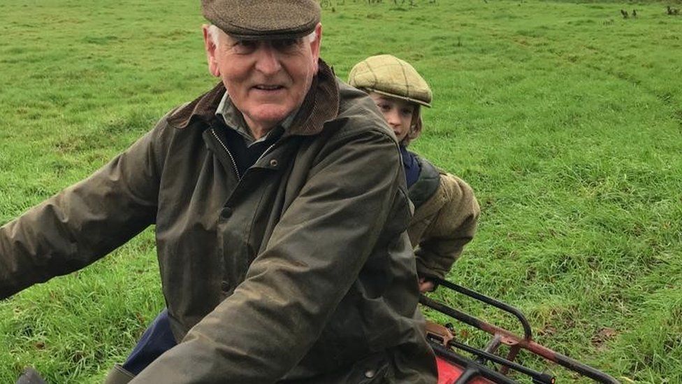 Francis Collingborn on a tractor with his grandson Maxi