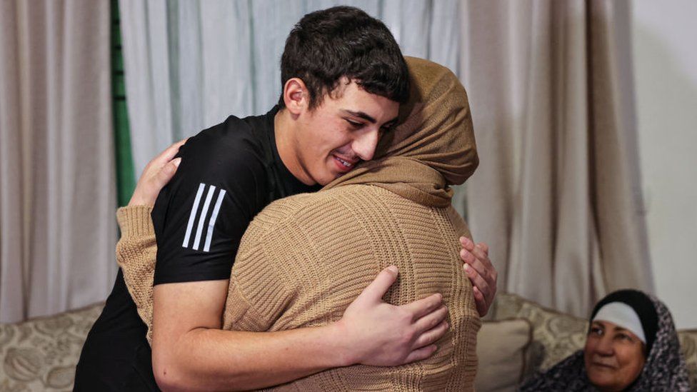 Muhammad Abu Al-Humus, a Palestinian former prisoner released from an Israeli jail, hugs his mother after returning to his home in east Jerusalem