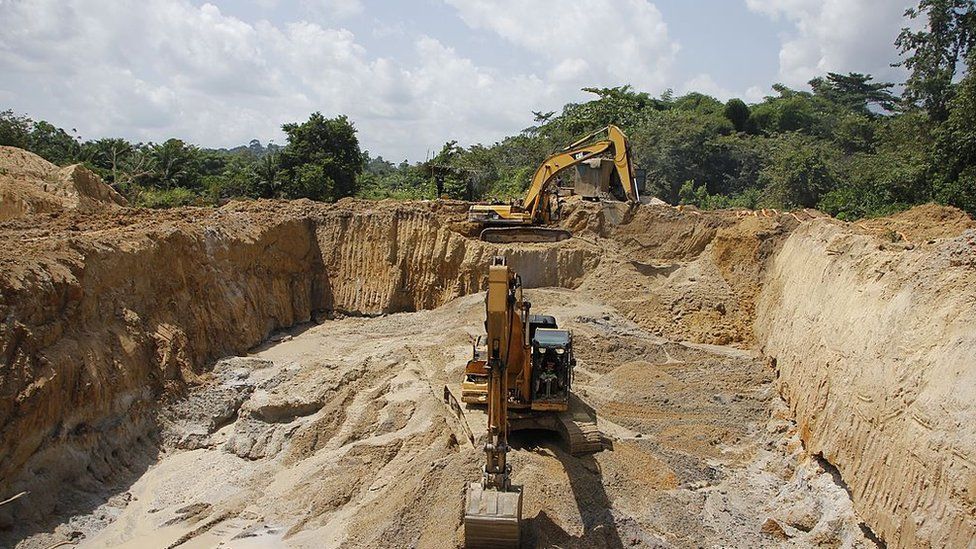 Excavators work on a small-scale mining site on June 16, 2013 near Dunkwa-on-Offin in the center of Ghana.