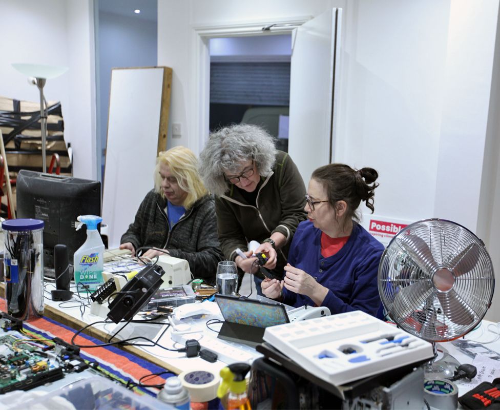 Volunteers repair electrical items at the Fixing Factory in Camden, London