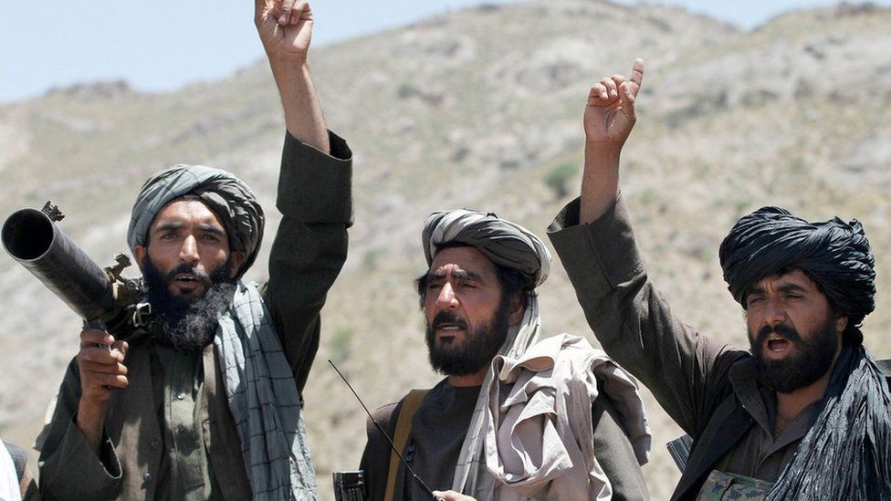 Taliban fighters carrying weapons cheers during a speech by their senior leader in the Shindand district of Herat province, Afghanistan. 27 May 2016.