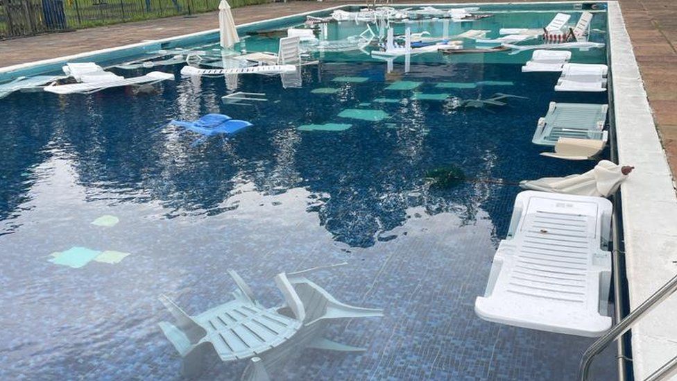 Furniture thrown into a swimming pool
