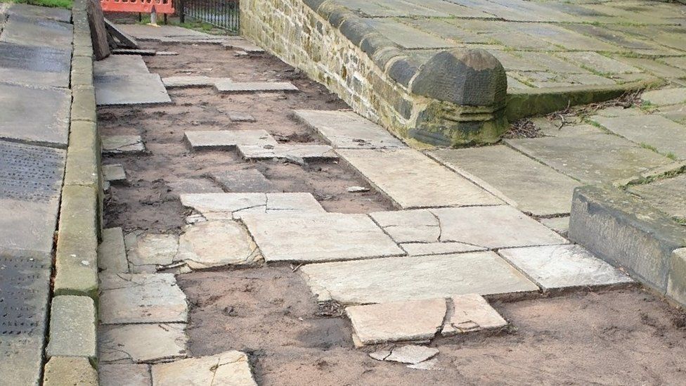 Ormskirk Parish Church path showing missing York stone slabs