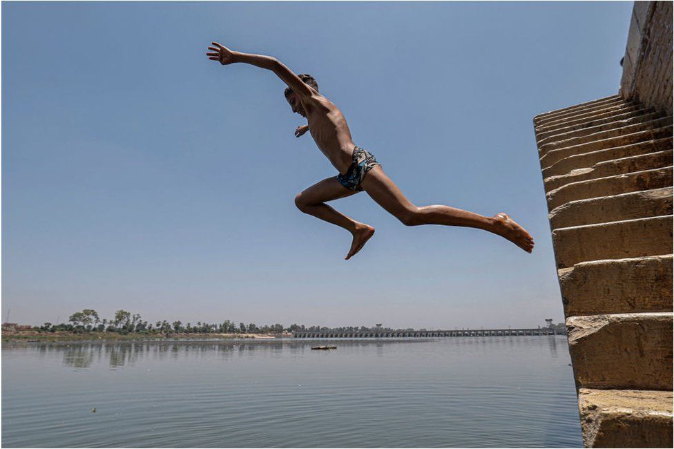 A boy diving into the River Nile