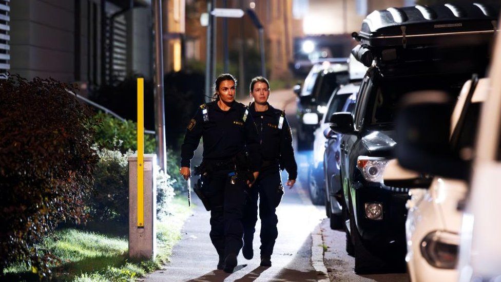 Police patrol at the scene after a shooting in Jordbro, Sweden, 28 September 2023