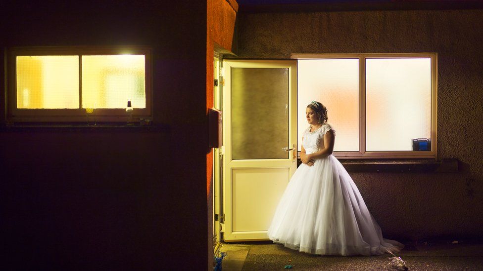 Woman in wedding dress outside function room