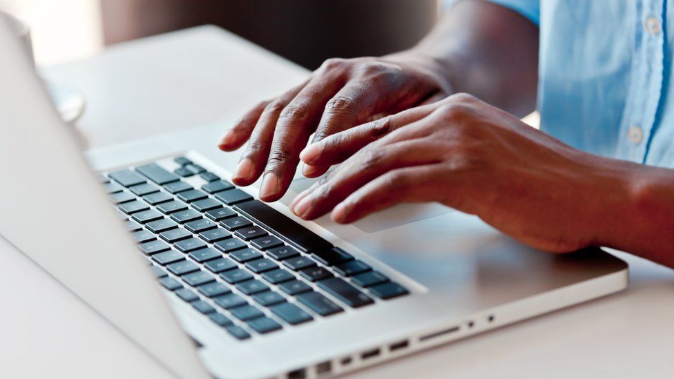 Man typing on laptop