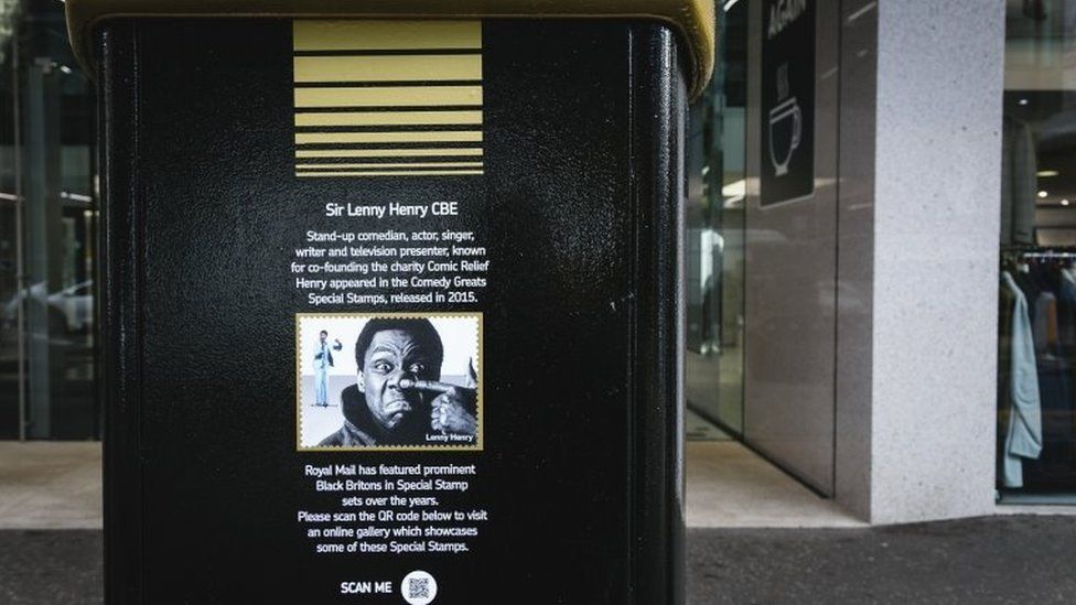 A black postbox featuring an image of Sir Lenny Henry in Bedford Street, Belfast