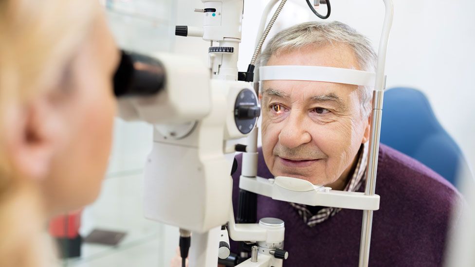 Optician examining patient