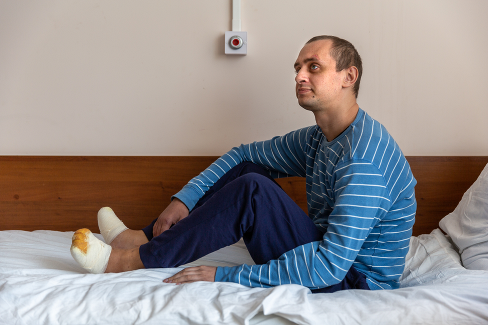 Nikita Horban sits on his hospital bed in Kyiv. He has begun to take a few steps.