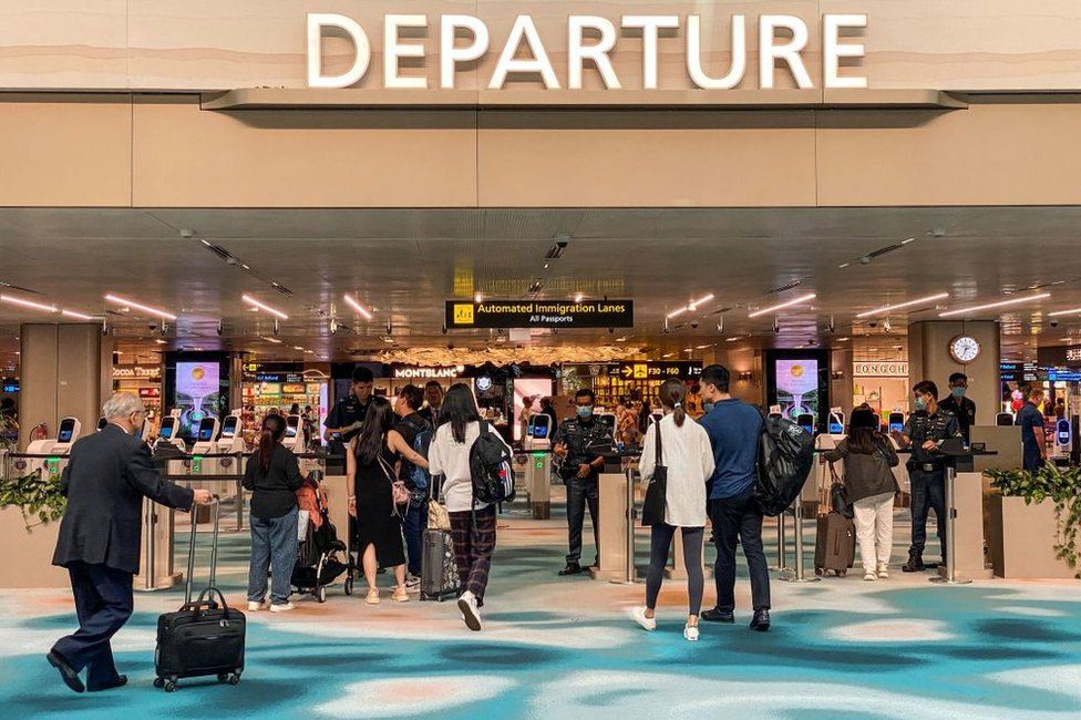 Travellers arrive at the departure hall in Singapore Changi airport in Singapore on March 31, 2023.