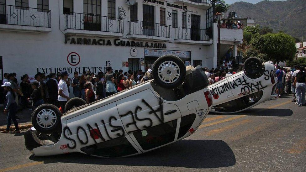 Overturned cars during a protest in Mexico