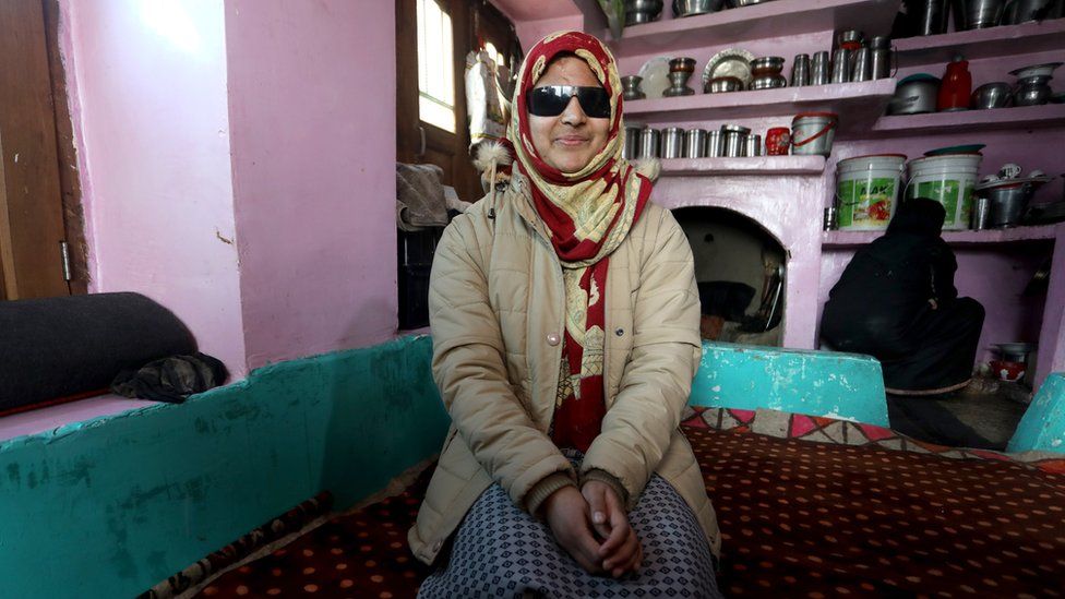 Ms Mushtaq smiling at her home in Kashmir