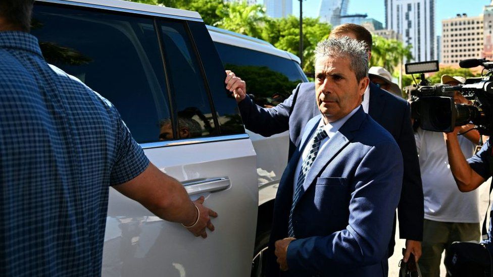 Carlos de Oliveira arrives at his arraignment