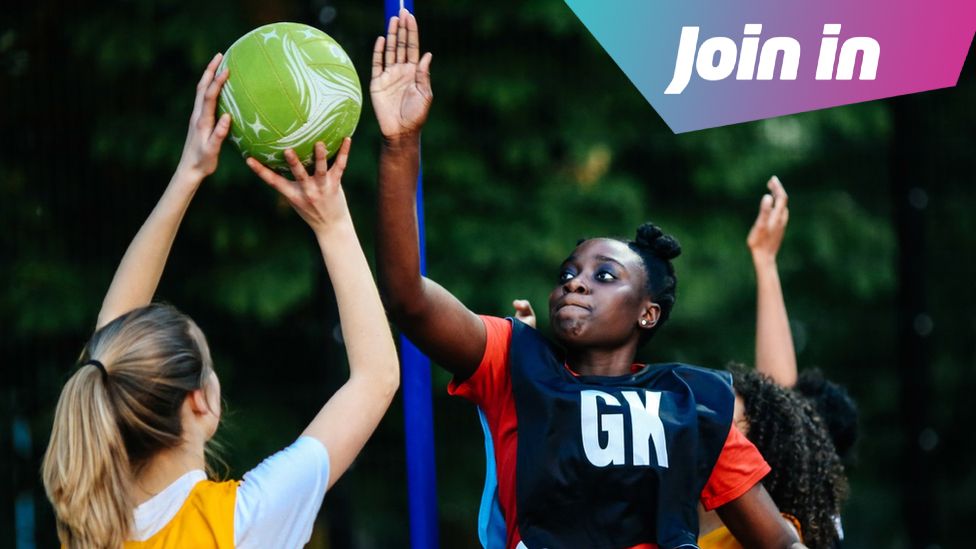 Two girls playing netball