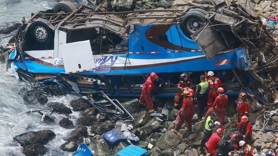 A group of emergency personnel working to rescue victims after a passenger bus plunged off the Pan-American Highway North, about 45 kilometres from Lima, Peru, 02 January 2018.