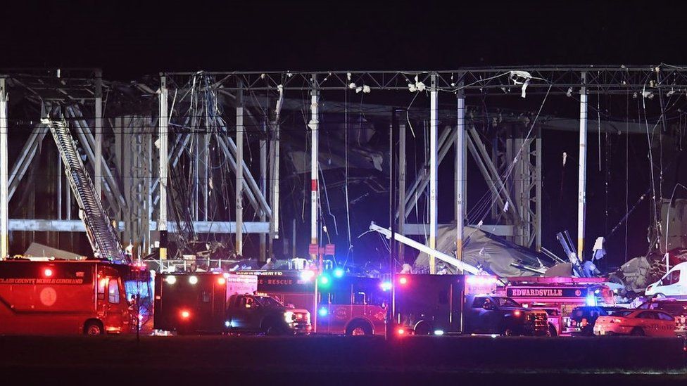 irst responders surround a damaged Amazon Distribution Center on December 10, 2021 in Edwardsville, Illinois.