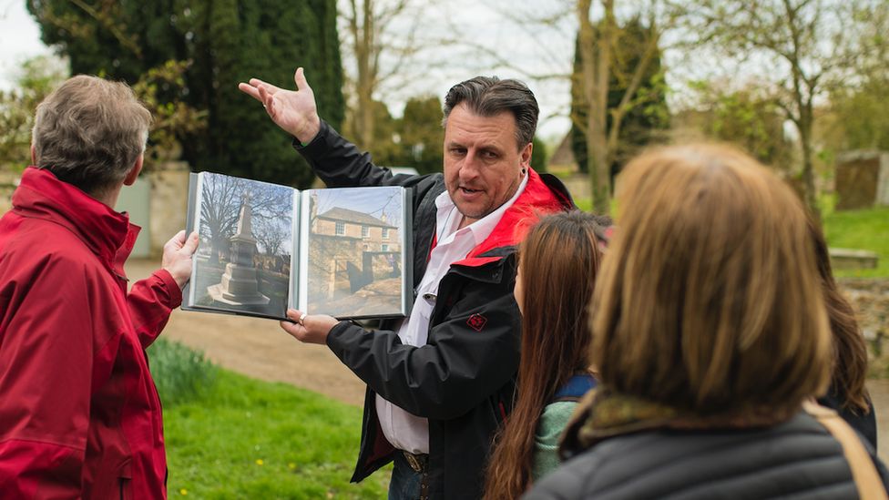 A Tourist England guide leading a tour