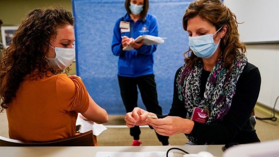Healthcare workers take part in a rehearsal for the administration of the Pfizer coronavirus vaccine