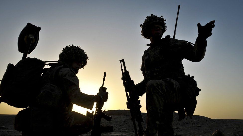 British soldiers from the 1st Battalion Royal Regiment Fusiliers take a knee as they conduct a dawn foot patrol in the Nahr-e Saraj district, Helmand Province, Afghanistan in 2013