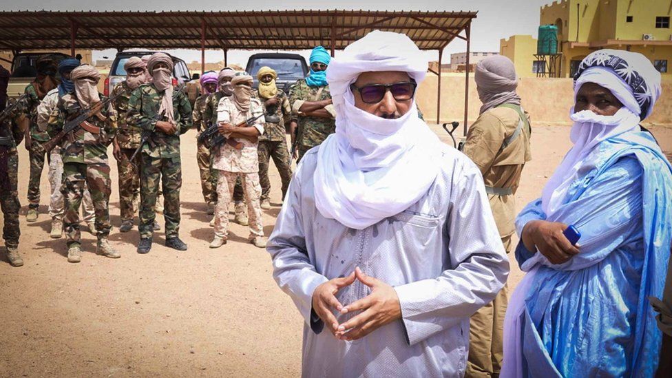 Bilal Ag Sharif, the local Tuareg leader, stands in front of some of his troops