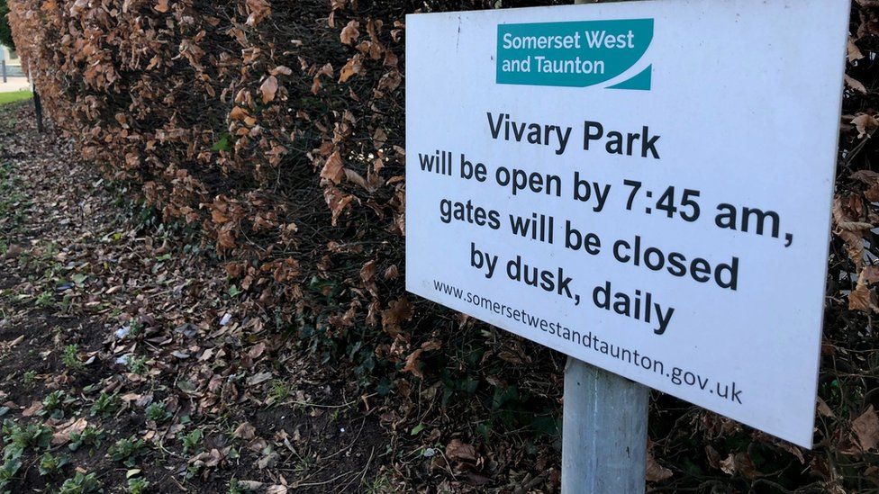 a sign saying park opening times
