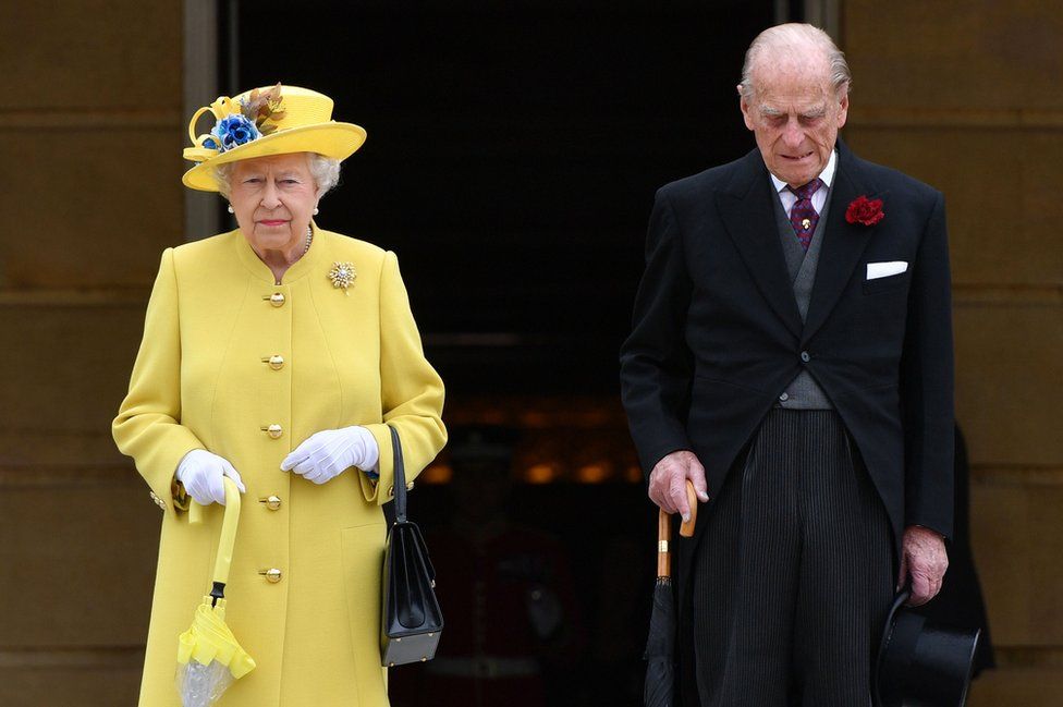 Queen Elizabeth II and the Duke of Edinburgh observing a minute's silence at the start of a garden party at Buckingham Palace in London, 23 May 2017