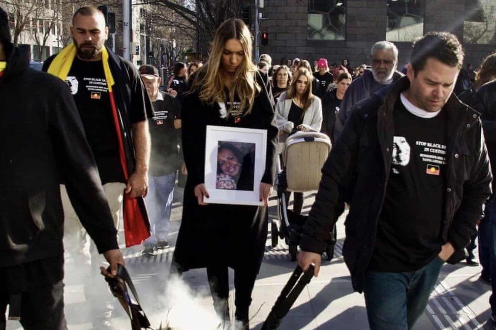 Apryl Day holds a picture of her mother Tanya Day as she leads a march in Melbourne protesting against the deaths of Aboriginal people in custody
