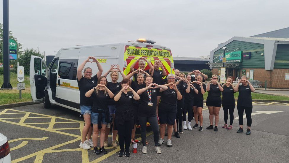 SPB volunteers stand with the charity's van in a car park