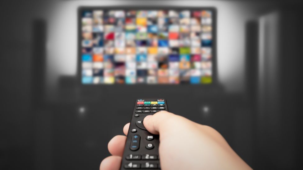 A remote control pointing towards a TV