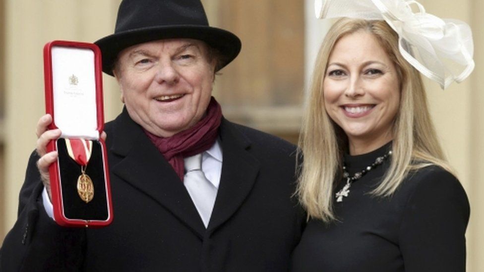 The musician was accompanied by his daughter Shana Morrison at Buckingham Palace