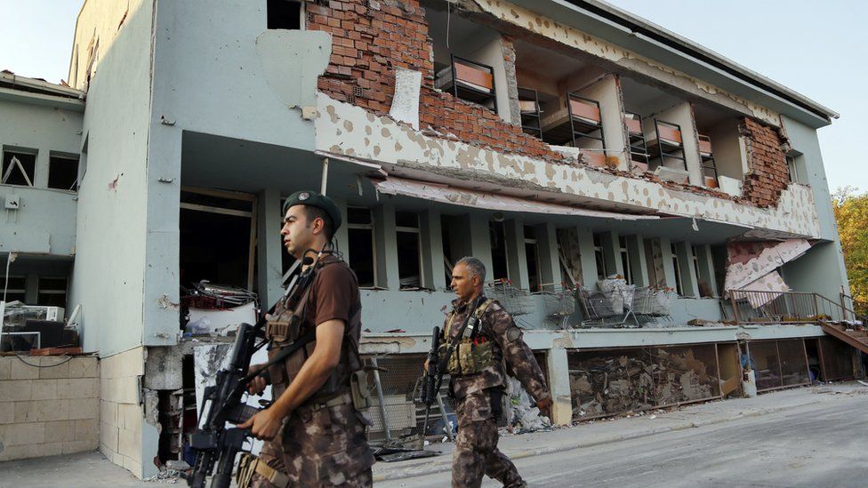 Turkish special forces patrol damaged base which was attacked by warplanes during failed military coup in Ankara, Tuesday, July 19, 2016