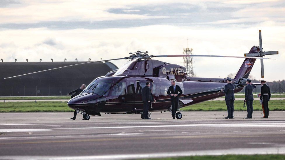 Prince William stepping off a helicopter