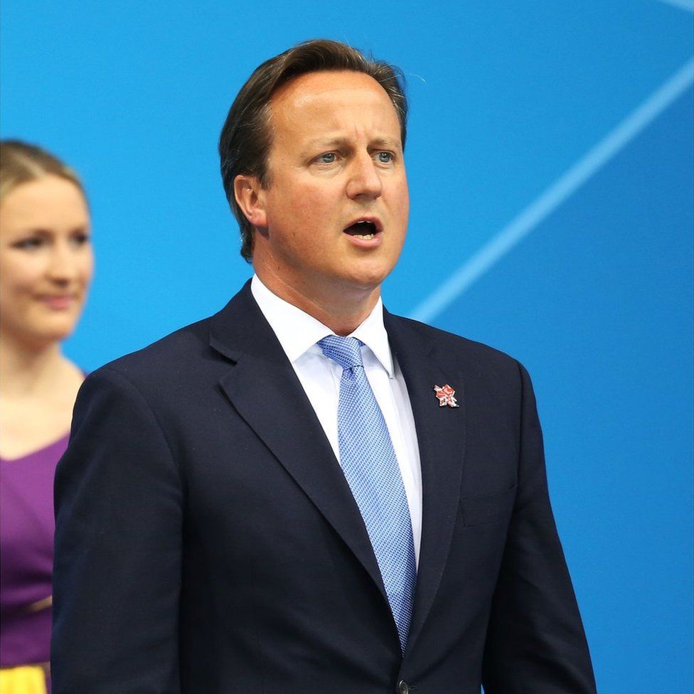 David Cameron sings the national anthem after presenting Eleanor Simmonds with her gold medal on day 5 of the London 2012 Paralympic Games at Aquatics Centre on September 3, 2012 in London, England