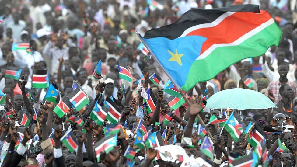 Thousands of Southern Sudanese wave the flag of their new country during a ceremony in the capital Juba to celebrate South Sudan's independence from Sudan