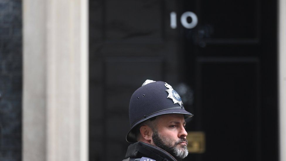 A police officer passes 10 Downing Street in London