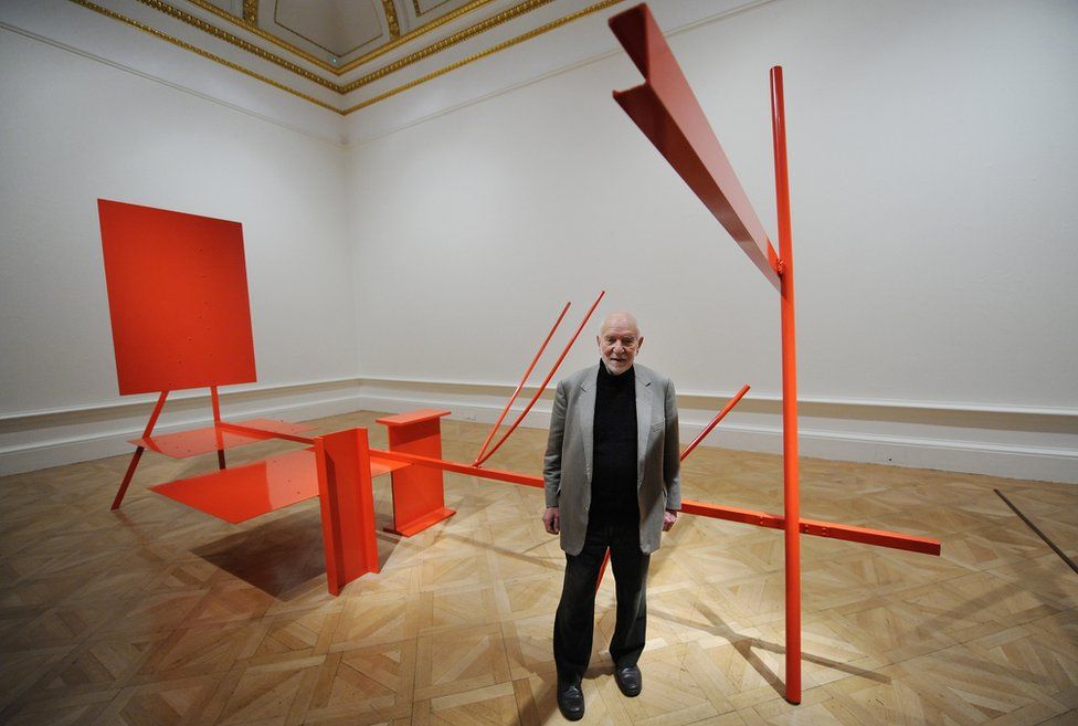 Anthony Caro with his sculpture Early One Morning at the Royal Academy of Arts in London, 18 January 2011.